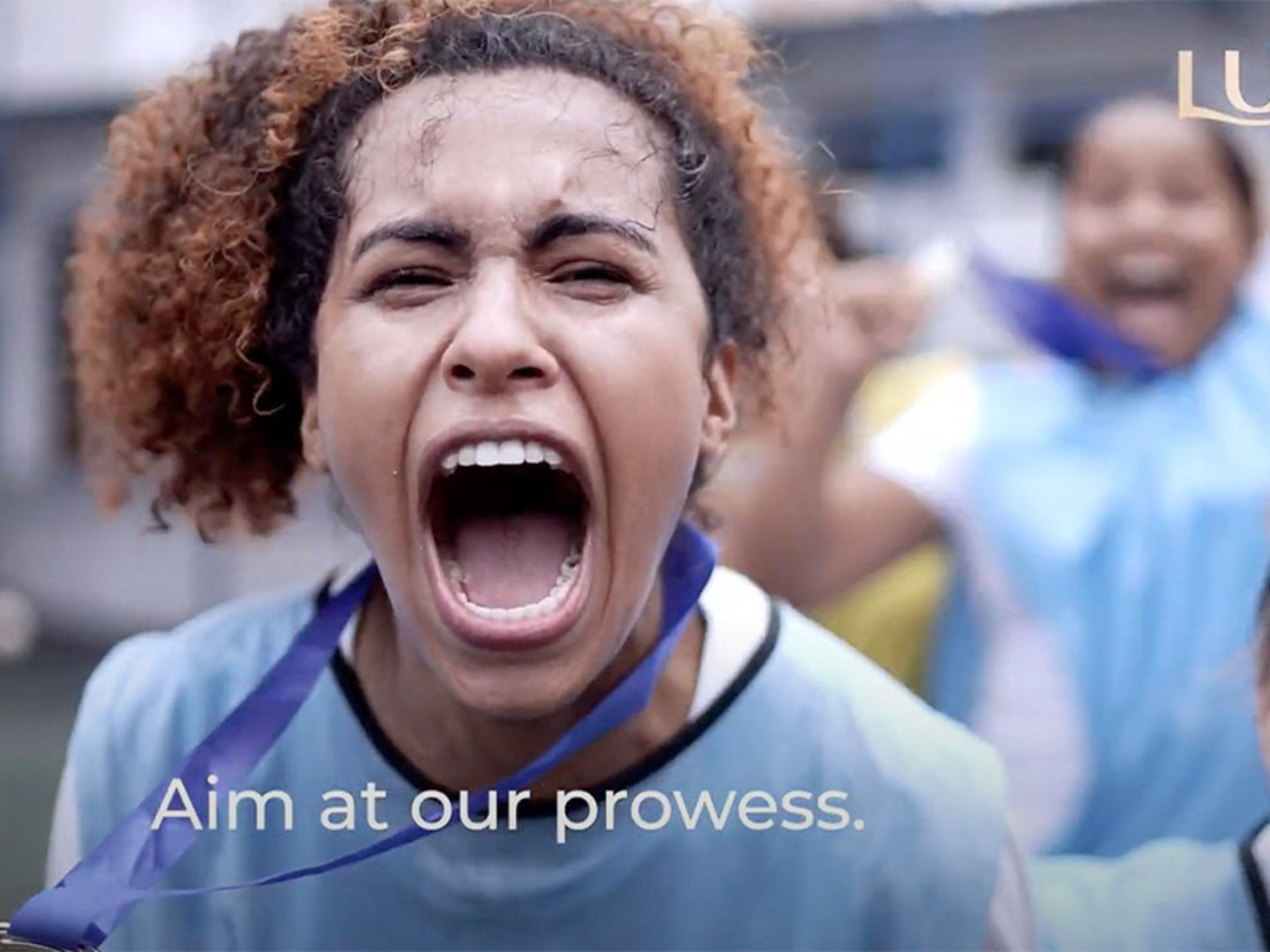 Girl playing sport, screaming with text that reads 'aim at our prowess'