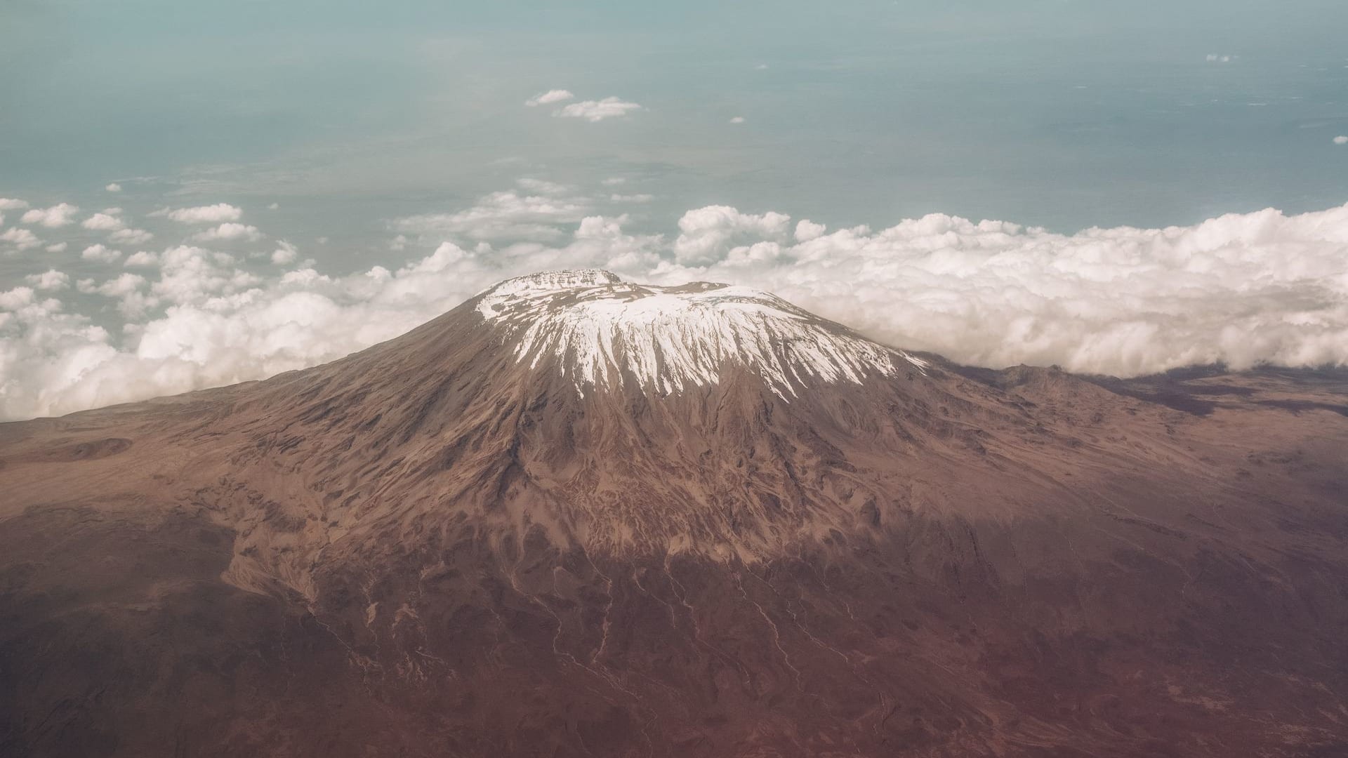 Mount Kilimanjaro snow-capped peak above the clouds