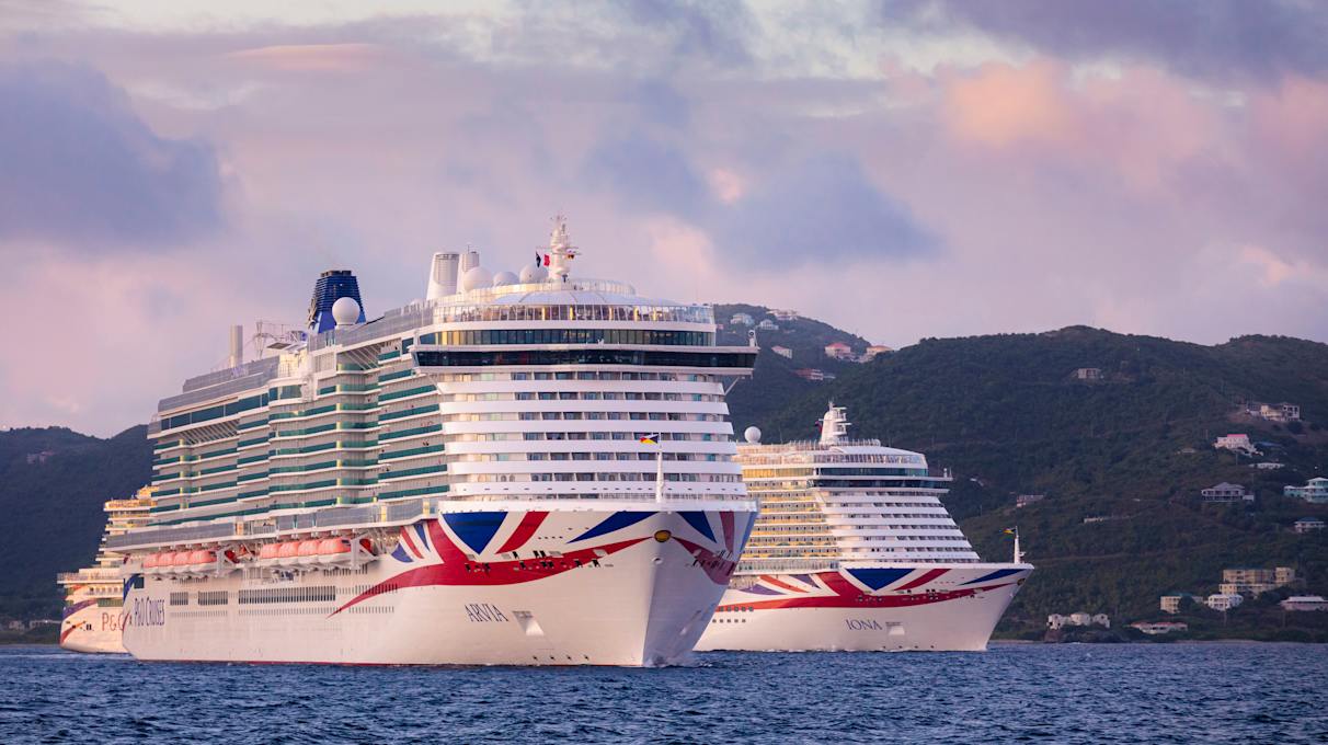 As the sun sets, P&O Cruises two largest ships, Excel class Arvia and Iona depart from Tortola, British Virgin Islands, yesterday,
