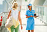 Waitress with drinks walking on deck, guest walking on deck