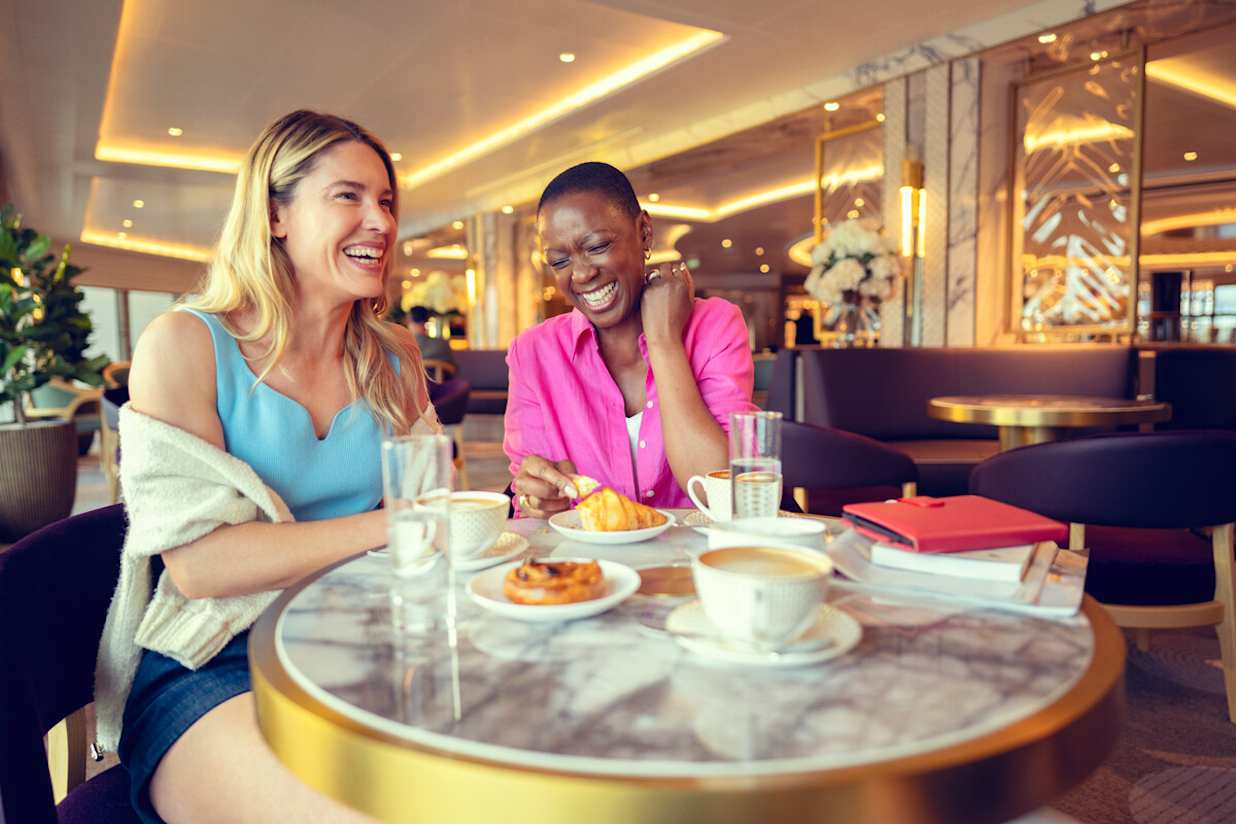 Two women having coffee on Cunard ship in The Carinthia Lounge