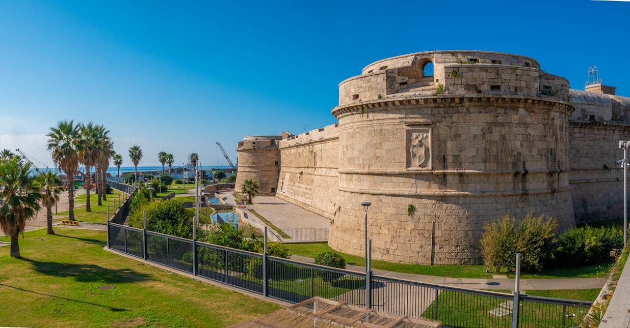 Water front park and ruins of the Fortezza Michelangelo fort in the port city of Civitavecchia, Lazio, Italy