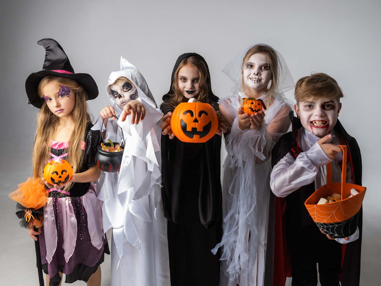 Group of kids dressed up in Halloween costumes