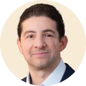 headshot of a man in a blazer with a neutral background, professional portrait, confident expression, corporate style