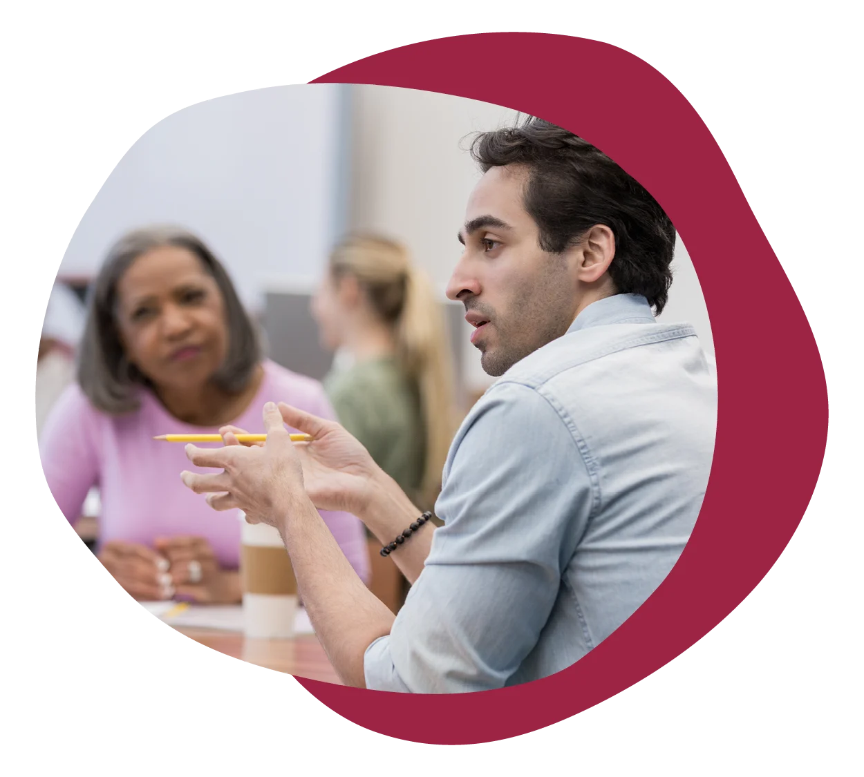 young man engaging in discussion with interested listeners in a collaborative environment, group discussion with engaged participants
