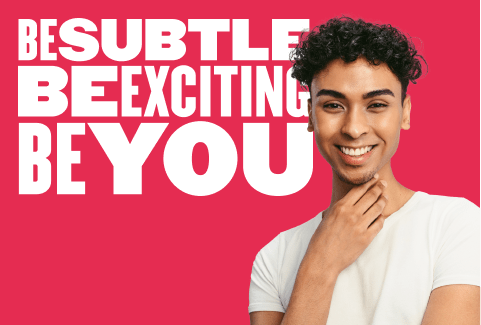 be subtle be exciting be you, smiling young man in casual white shirt against vibrant pink background