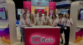 Hi Bob team at trade show booth, showcasing branding and engaging with attendees, Group of professionals in branded attire at event