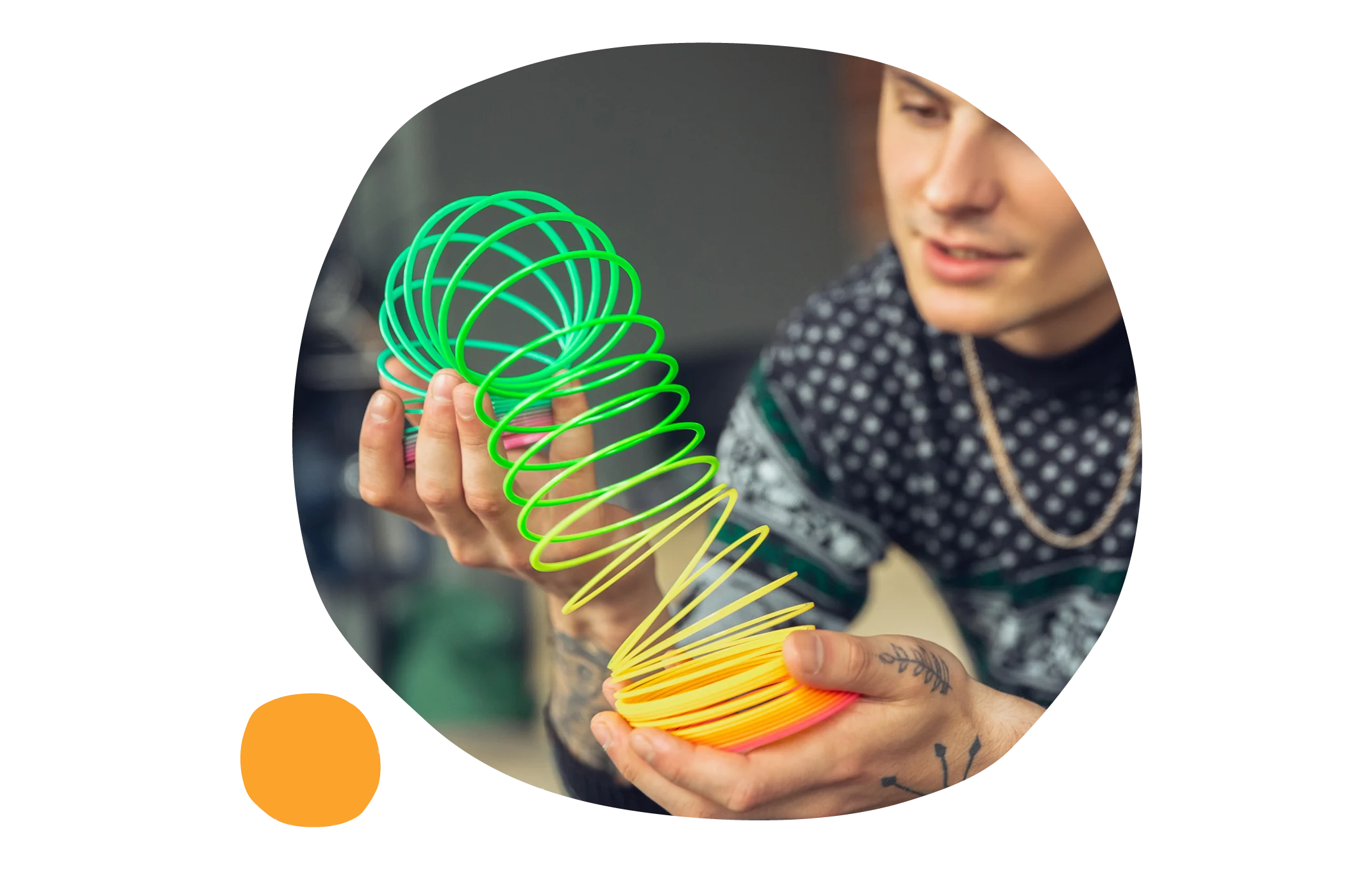 colorful spring toy, person holding spring toy in hands