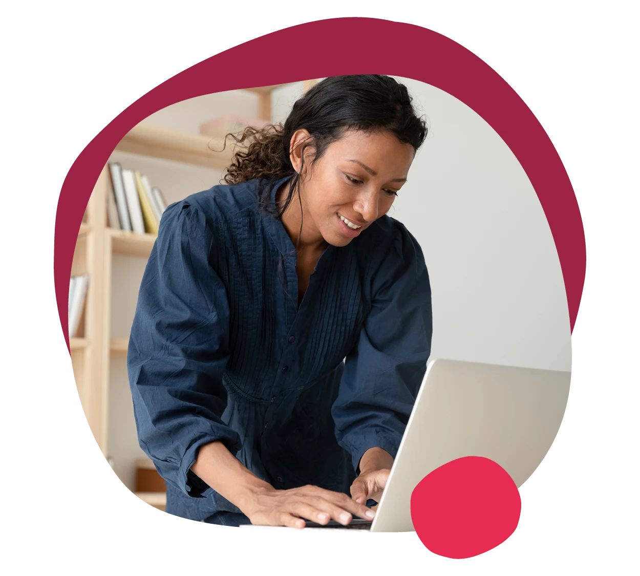 focused woman working on laptop in a minimalistic workspace with bookshelves in the background, remote work productivity