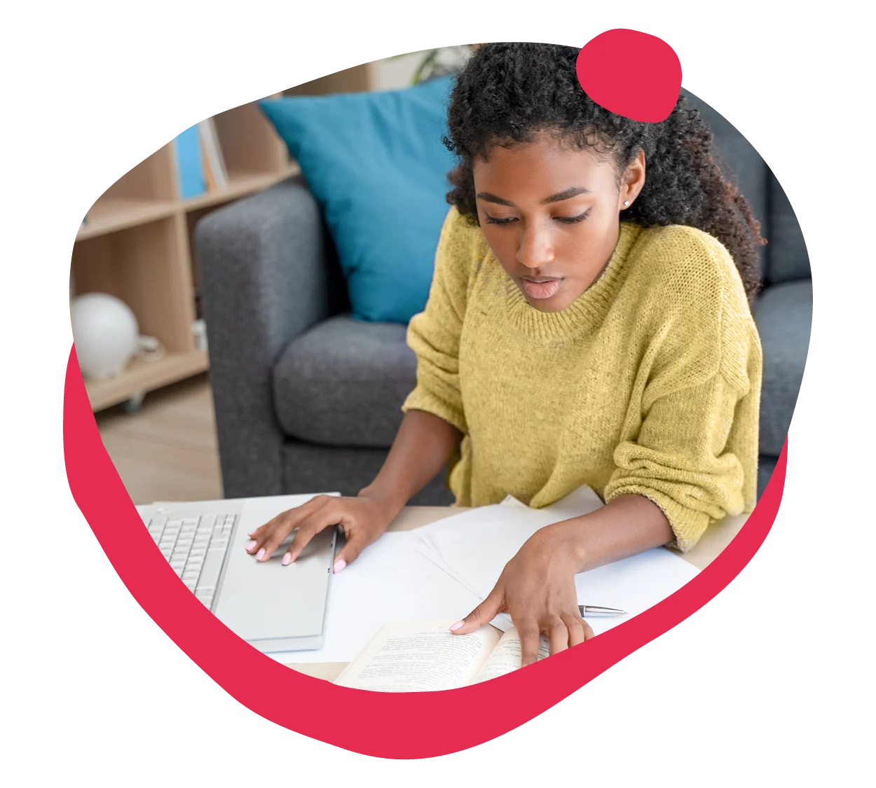 young woman studying at a laptop with papers and a book in a cozy living space, focused learning and productivity in home office