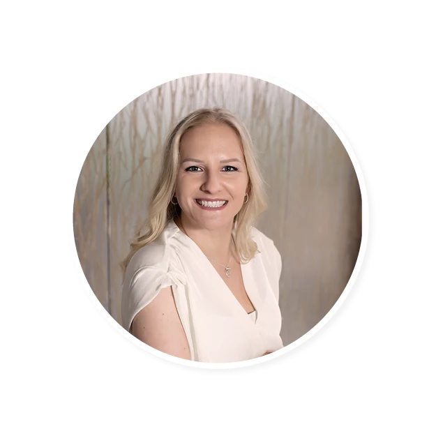 smiling woman with long blonde hair in white blouse against soft abstract backdrop, professional portrait with natural lighting