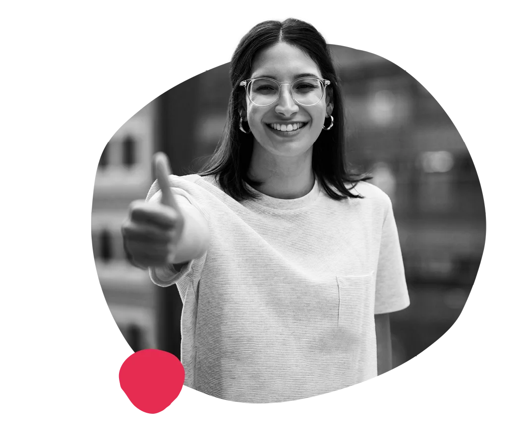 smiling woman giving thumbs up in casual style with a blurred background, black and white portrait with colorful accent shapes