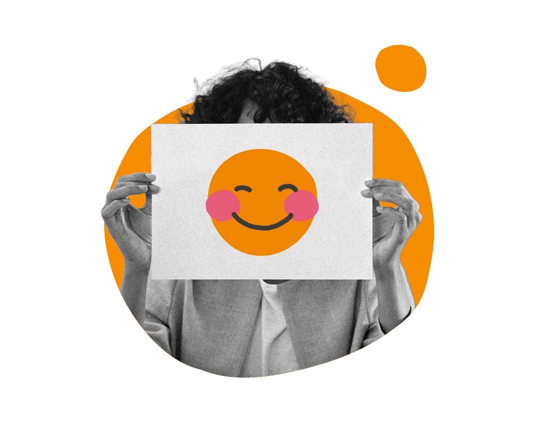 smiling emoji held by hands in front of a colorful background, person showing cheerful expression with artful design