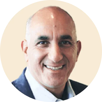 smiling man in a round frame wearing a suit against a light background, professional portrait with a welcoming expression