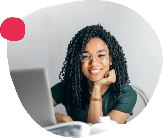 smiling woman with curly hair at laptop in modern workspace, businesswoman working remotely at home office