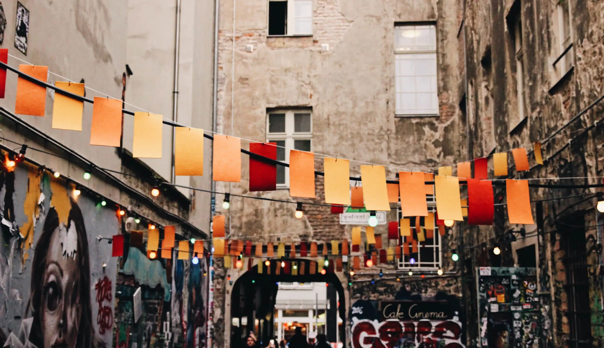 colorful banners, graffiti-filled alleyway