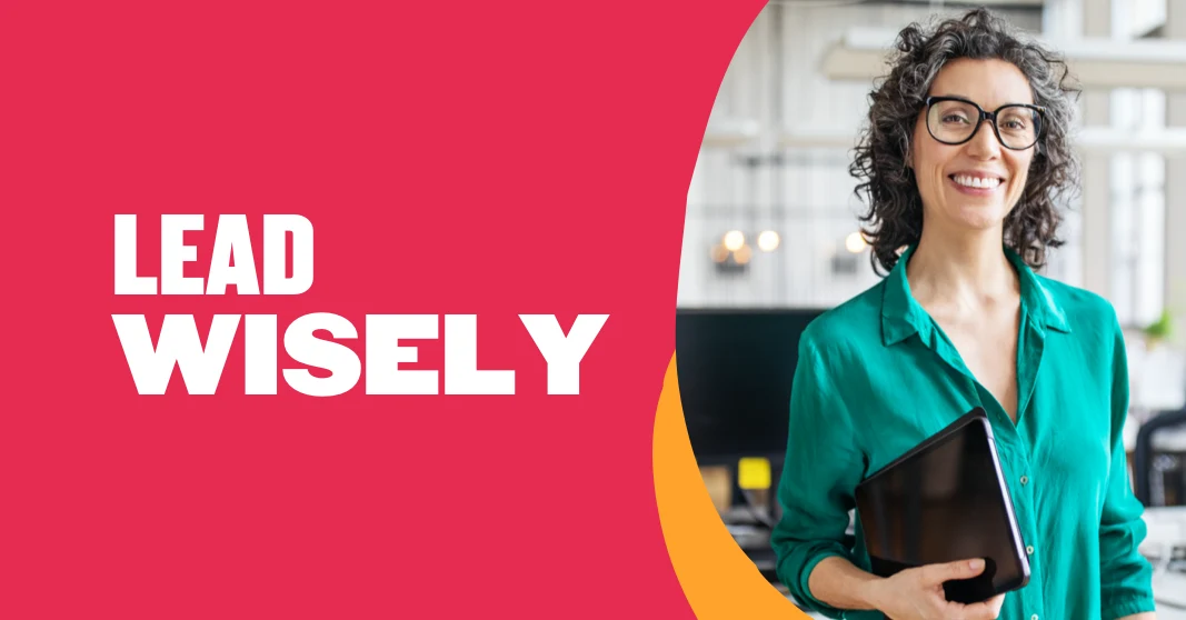 lead wisely, confident woman smiling in green shirt holding tablet in bright office setting