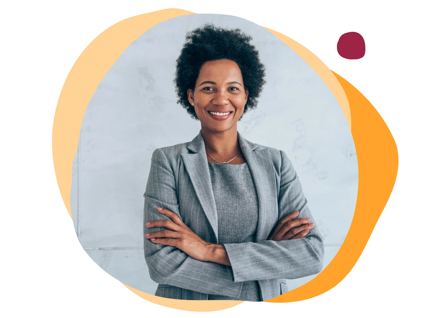business professional, smiling woman in gray suit with arms crossed against a light backdrop