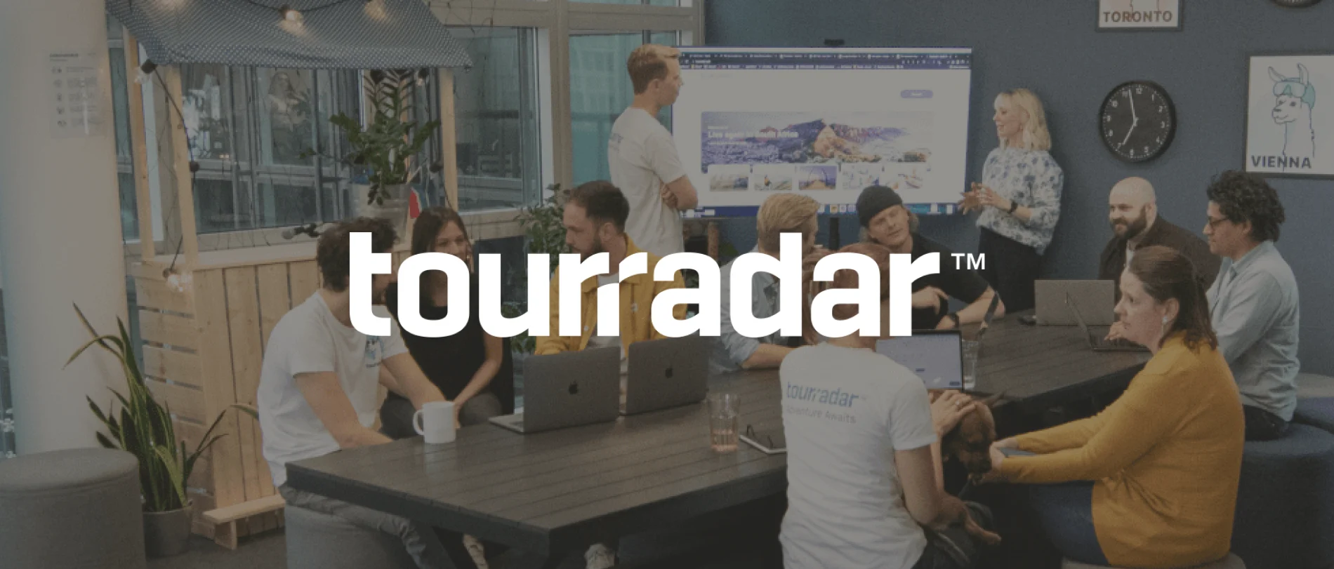 team brainstorming session, modern office with laptops and informal seating