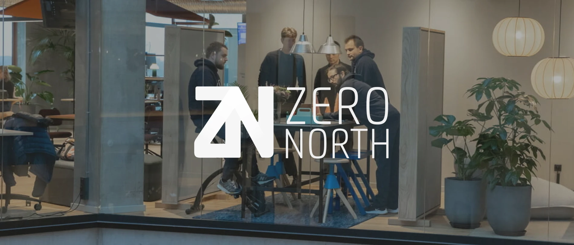 office meeting, modern workspace with plants and pendant lights, featuring team collaboration at Zero North