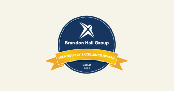 Brandon Hall Group gold award badge for Technology Excellence 2023, featuring a blue circular design with yellow ribbon. , BrandonHallGroup, TechnologyExcellenceAward