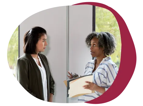 professional women discussing ideas, business collaboration in modern office setting