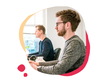 professionals working at computers, collaborative office environment