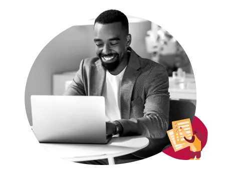 young man smiling at laptop, modern workspace with laptop and notes