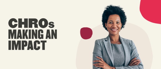 CHROs making an impact, smiling woman in gray suit with curly hair on a light background, professional leadership and empowerment