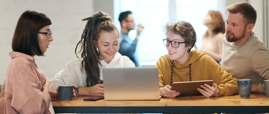 diverse group collaboration, casual work environment with laptops and tablets