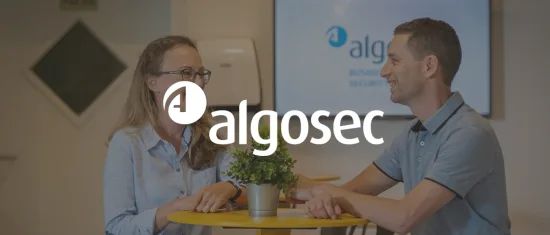 business meeting at algosec office with smiling professionals discussing around a table, modern workspace with plant decoration