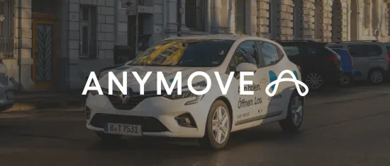 renault car parked on city street with 'ANYMOVE' branding and large windows reflecting building details, urban vehicle with clear branding on the door
