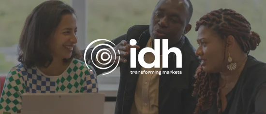 people engaging in discussion, idh logo with tagline, backgrounds of a work environment