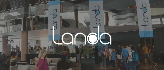 Landa event banner in a busy lobby with attendees networking and modern decor., Conference atmosphere with Landa branding.