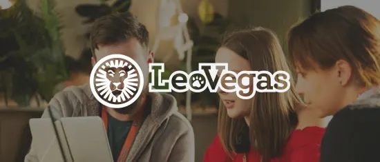 professional team discussing on a tablet at a modern workspace with plants, featuring the LeoVegas logo, team collaboration in stylish office setting