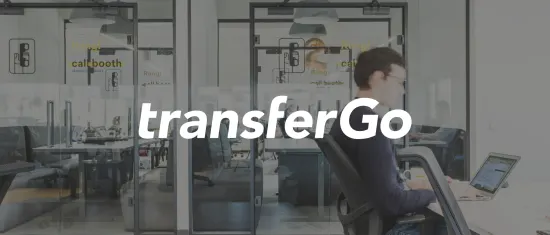 office environment, transferGo branding with glass walls and employees working in a collaborative space