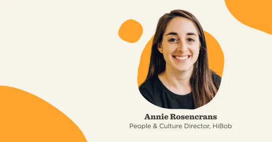 Annie Rosengrans, People & Culture Director at HiBob, smiling against a soft, abstract background with orange accents., AnnieRosengrans, PeopleCultureDirector