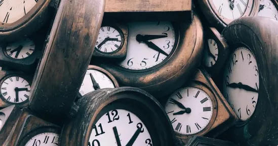 clocks stacked together with varying designs and styles, showcasing multiple time displays, vintage wall clocks emphasizing time's passage