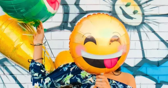 smiling emoji balloon, colorful backdrop with fruit balloons