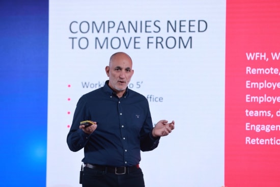 speaker addressing companies' transition, presentation on workplace evolution and remote work strategies