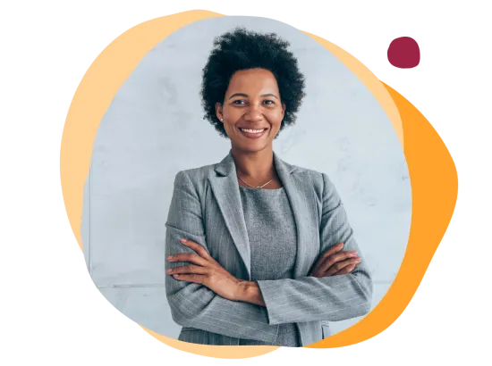 business professional, smiling woman in gray suit with arms crossed against a light backdrop