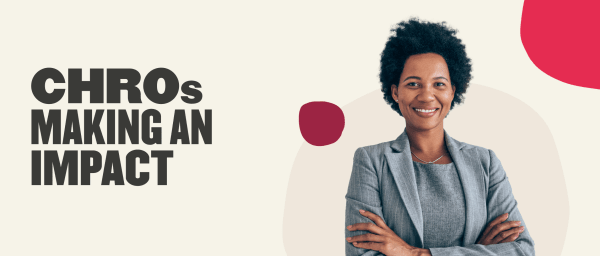 CHROs making an impact, smiling woman in gray suit with curly hair on a light background, professional leadership and empowerment