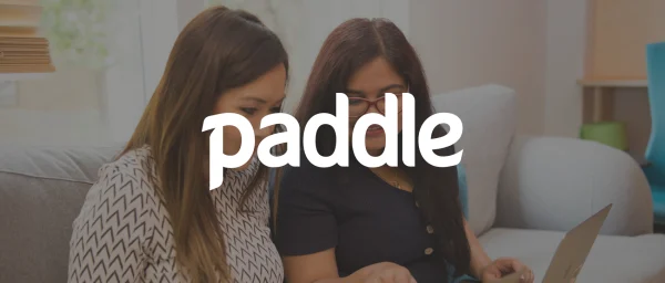 paddle, two-women-working-on-laptop-in-modern-office-space