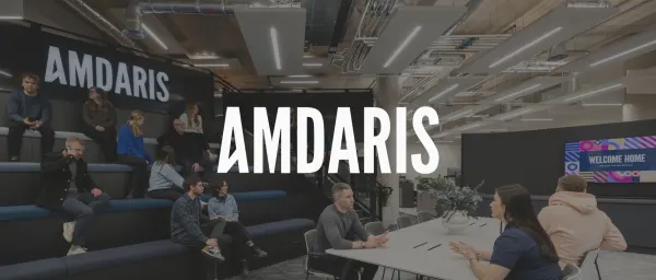Amdaris office space featuring modern seating, collaborative areas, and vibrant digital signage with a welcoming message., Modern office design with Amdaris brand display and collaborative workspace for team interaction.