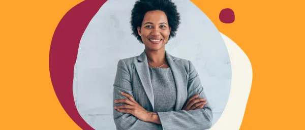 businesswoman in a gray suit posing confidently with crossed arms in front of a colorful abstract background, confident professional woman smiling in a modern office setting