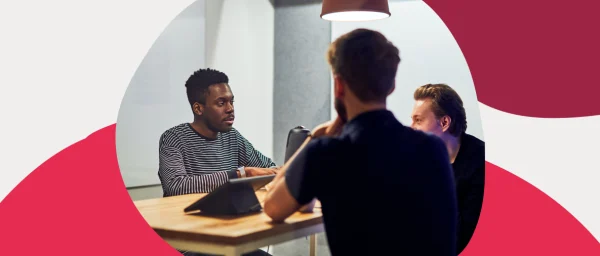 collaborative business meeting with diverse participants discussing ideas, modern workspace with warm lighting and casual attire