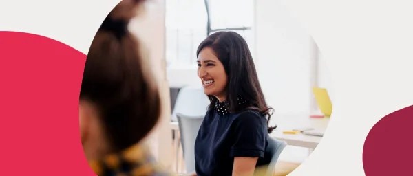 smiling woman in stylish outfit in bright work environment, casual office setting with modern furniture and colors