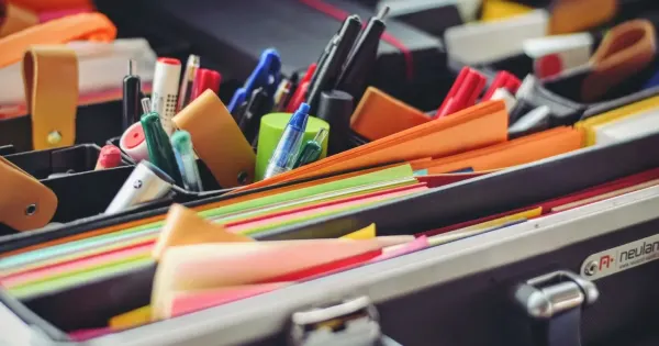 stationery supplies, colorful papers and pens in an organized case