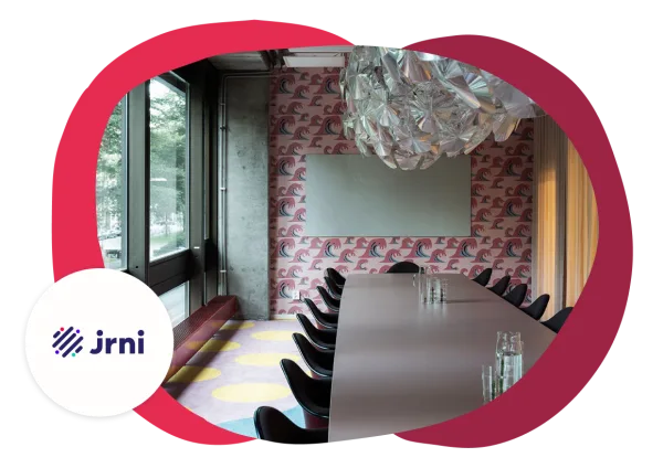 conference room with modern decor, vibrant wave-patterned wallpaper, large table, and stylish chandelier, brightly lit space with sleek black chairs and colorful flooring