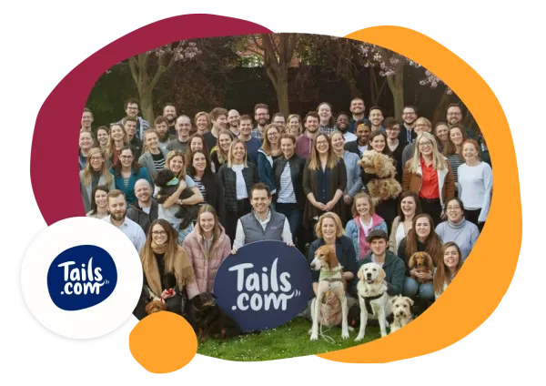 Tails.com team group photo with dogs, showcasing unity and enthusiasm for pet care. Colorful branding elements visible. Tails.com, teamphoto, pets